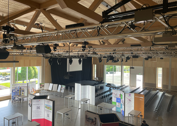 For an exhibition, the rigging system is equipped with speakers and spotlights.