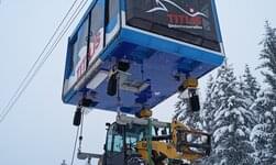 A construction machine is transported in the snow.