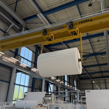 The two electric chain hoists of the overhead crane work together to lift the load beam carrying the paper roll.